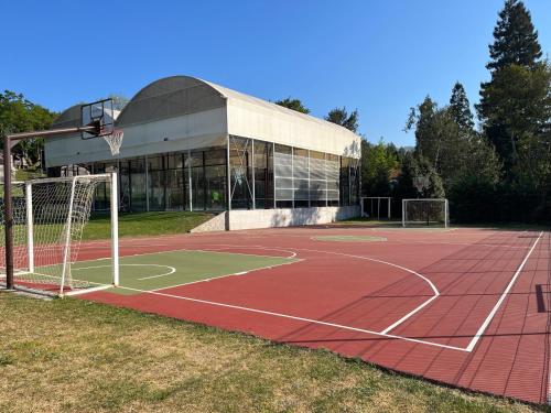 a basketball court in front of a building at Camping Deva in Deva
