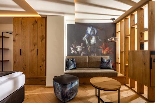 a living room with a couch and a table at Hotel Königssee in Schönau am Königssee