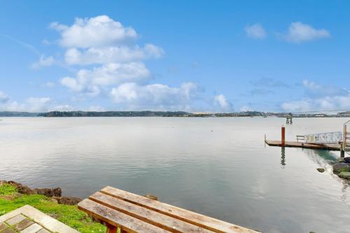 a view of a large lake with a wooden dock at Beautiful Briny Retreat in Newport
