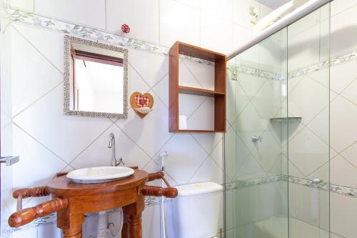 a bathroom with a sink and a shower at Pousada Villa Martins in São Miguel do Gostoso