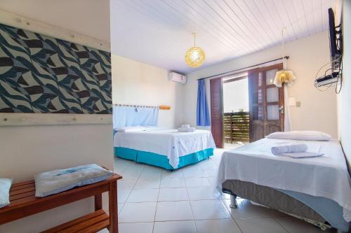 Ένα ή περισσότερα κρεβάτια σε δωμάτιο στο Pousada Villa Martins