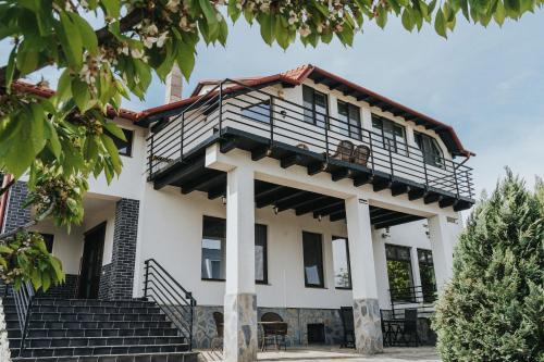 a house with a balcony on top of it at Diplomat Villa in Baile Felix