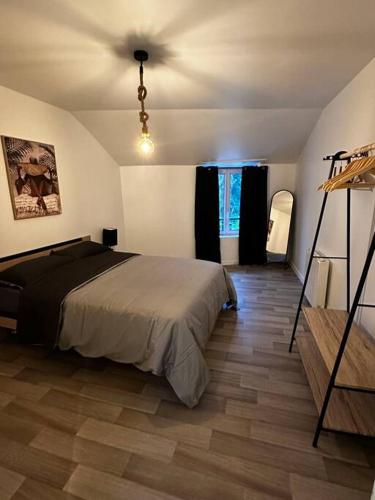 a bedroom with a bed and a wooden floor at Le Cosy'ppart - EasyLife in Bourgoin