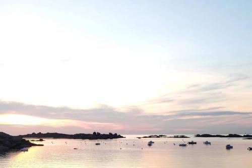 a group of boats in the water at sunset at Manoir de Kervegan : Le Logis du P’tit Levant in Lannion