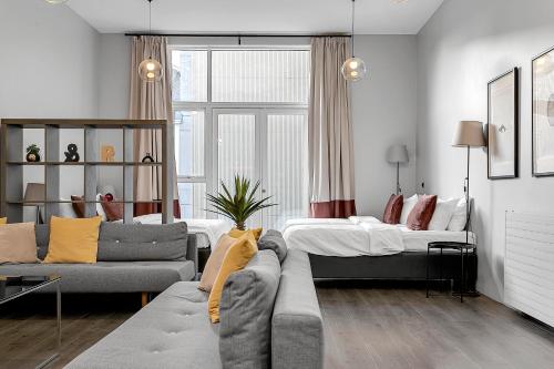 a living room with a couch and a bed at Máni Apartments in Reykjavík