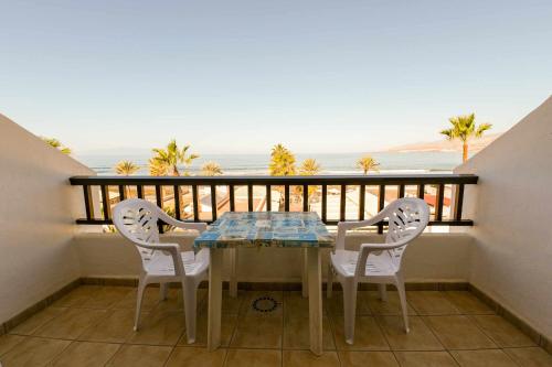 a table and chairs on a balcony with the ocean at Parque Santiago II 379 Tenerife Rental & Sales in Playa de las Americas