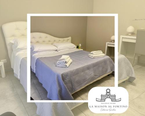 a bedroom with a bed with towels on it at La Maison al Fortino in Catania