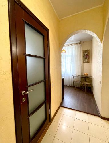 an open door in a hallway with a table at Naykova district Apartments in Kharkiv
