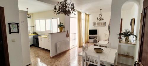 a kitchen with a table and a dining room at Casa Carmen in Faraján