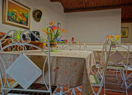a dining room with a table and chairs with flowers on it at Casa Stefy in Montagnana