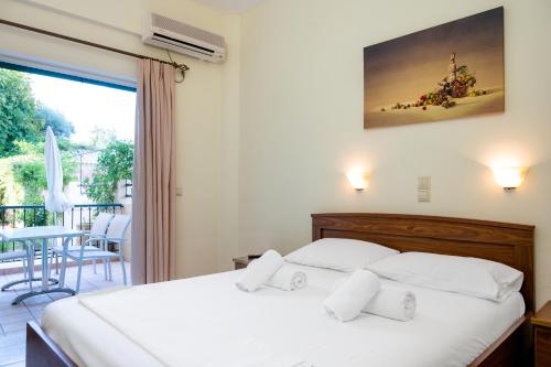a bedroom with a bed and a balcony at Konstantinos Hotel & Apartments I in Nydri