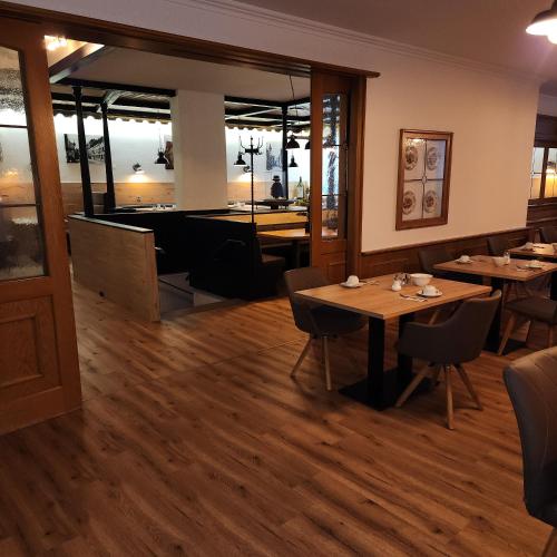 a dining room with tables and a pool table at Posthotel Traube in Donauwörth