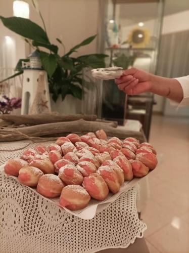 a tray of donuts sitting on top of a table at Hotel Ascot in Cervia