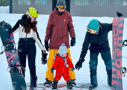 a group of people standing in the snow with a child at Hit the Sky in Sankt Christoph am Arlberg