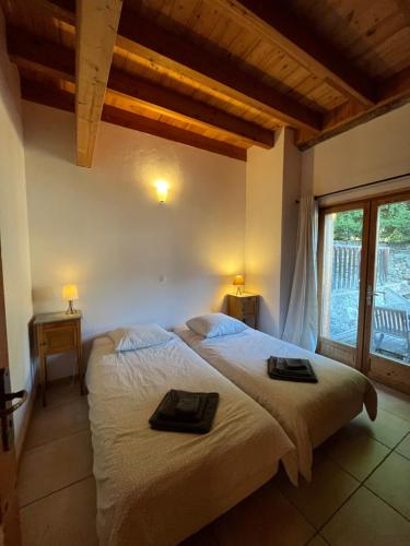 a bedroom with a large bed with two towels on it at Apartment Les Rousses 3 minutes from Alpe dHuez Grand Domaine via Oz en Oisans in Oz