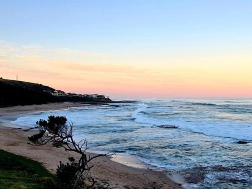 a view of the beach at sunset at Stumble Inn in Haga-Haga
