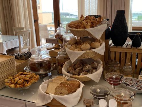 a table with many different types of bread and pastries at Hotel SJ in Tondela
