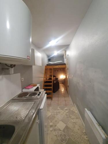 a small kitchen with a sink and a stove at Le logis ROOM in Nantes