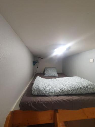 a bedroom with a bed and a light on the ceiling at Le logis ROOM in Nantes