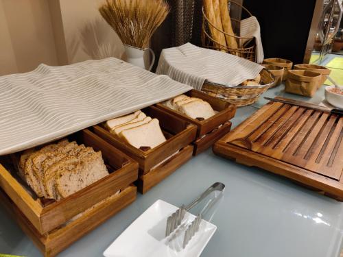 a table topped with two wooden trays of bread at Grums Hotel & Spa in Barcelona