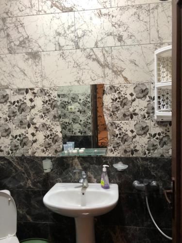 a bathroom with a sink and a mirror at hotel twins G&G in K'obulet'i