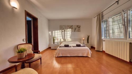 a large bedroom with a bed and a table and chairs at Costacabana - Villa Roxy in Lloret de Mar