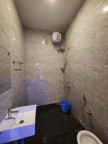 a bathroom with a sink and a toilet at Coffee valley resort (CVR) in Yercaud