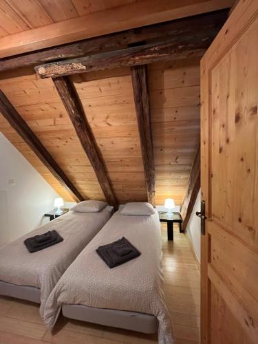 a bedroom with two beds in a attic at The Loft 3 minutes from Alpe dHuez Grand Domaine via Oz en Oisans in Oz