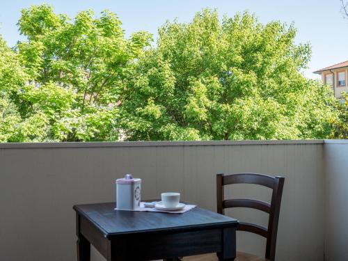 a table and chair with a cup of coffee on a patio at B&B Zelmirà in Rimini