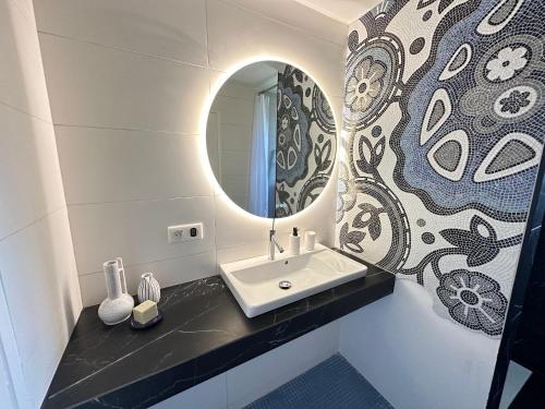 une salle de bain avec un lavabo et un miroir dans l'établissement Charmant T2 climatisé dans résidence sécurisée, proche plage - FR-1-309-394, à Collioure