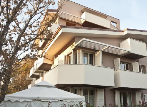a building with an umbrella in front of it at B&B Zelmirà in Rimini