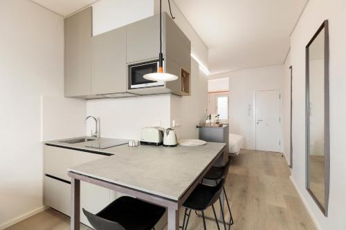 a kitchen with white cabinets and a counter top at Bcn Town Apartments Born in Barcelona