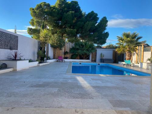 - une piscine dans une cour arborée dans l'établissement Magnifique villa individuelle climatisée 4 chambres avec piscine 11 m 5m, à Sérignan