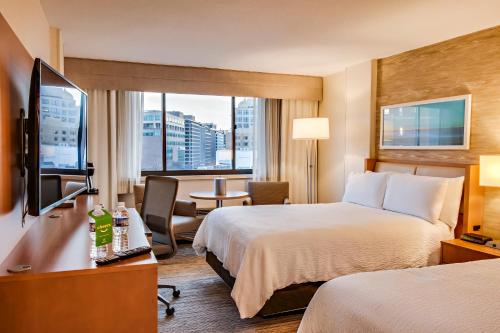 a hotel room with two beds and a television at Holiday Inn Washington-Central/White House, an IHG Hotel in Washington