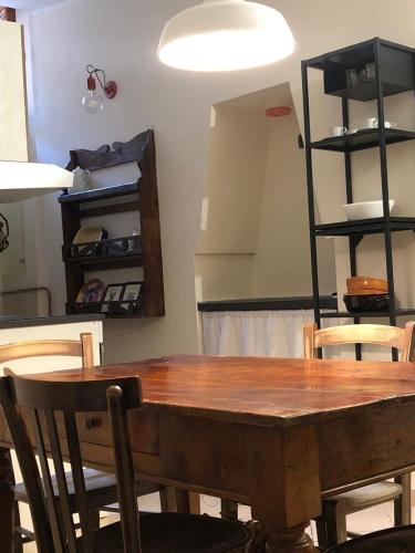 una mesa de madera y sillas en una habitación en Torri e Campanili, en Ascoli Piceno