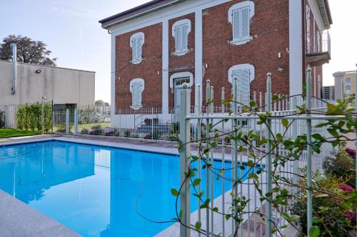 - une piscine en face d'un bâtiment en briques dans l'établissement La Villa, à Novara