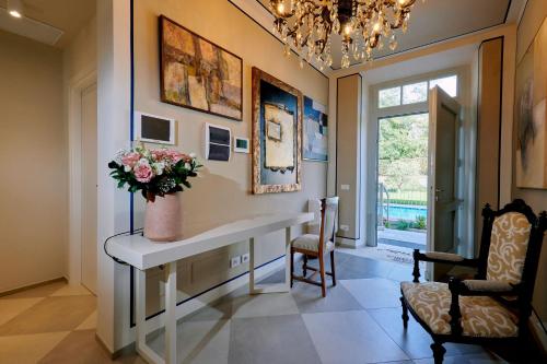 a home office with a desk and a vase of flowers at La Villa in Novara