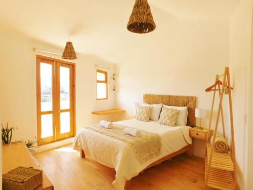 a bedroom with a bed and a window at La Casa de las Aves - Architect's House/ Amazing view & garden in San Cristóbal de Las Casas