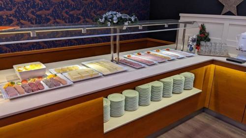 a buffet line with plates and desserts on display at Morada Hotel Arendsee in Kühlungsborn