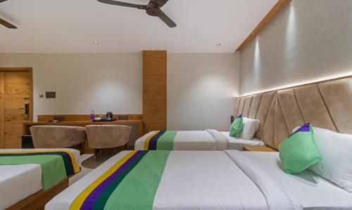 Ein Bett oder Betten in einem Zimmer der Unterkunft Treebo Tiba