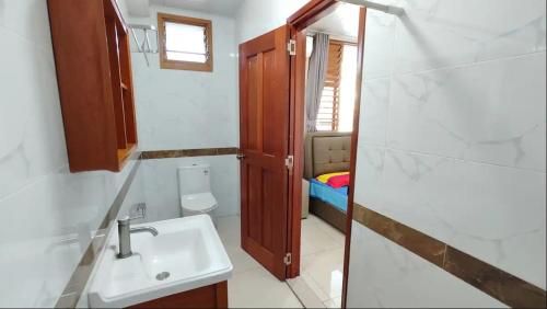 a bathroom with a sink and a toilet at Modern Master bedroom B in Nadi