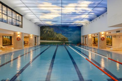 a swimming pool with a painting on the wall at Liberté Hotels Oran in Oran