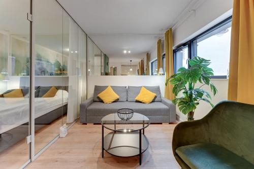 a living room with a couch and a table at Rezydencja Wintera by Grand Apartments in Gdańsk