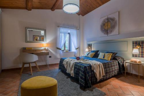 a bedroom with a bed and a table and a chair at Villa Durante in Cagli