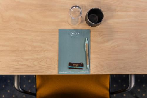 a desk with a pen and a cup of coffee at The Lodge Billund in Billund