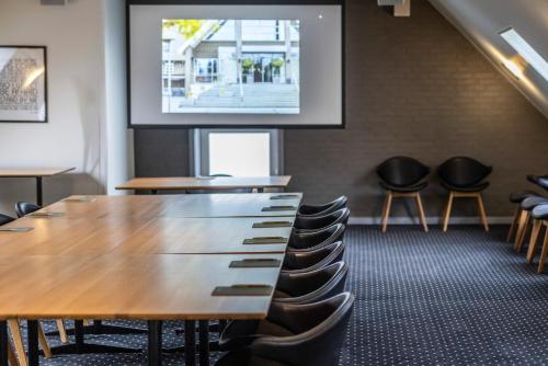 a conference room with a table and chairs at The Lodge Billund in Billund