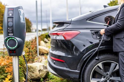 a person fueling a car at a charging station at The Lodge Billund in Billund
