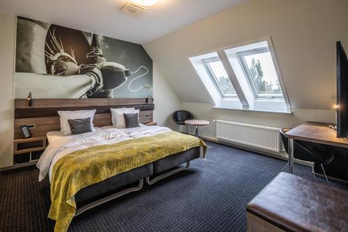 a bedroom with a large bed and a window at The Lodge Billund in Billund