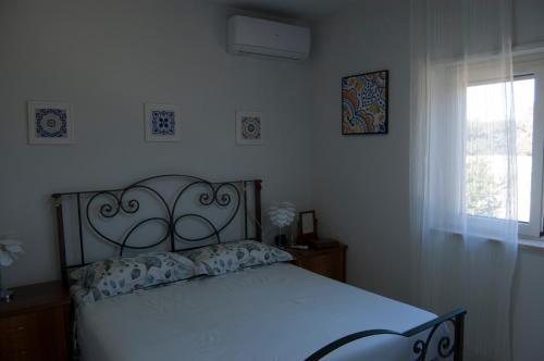 a bedroom with a bed and a window at Villa Tiziana in Pizzo
