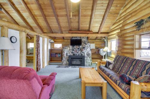 a living room with a couch and a fireplace at Rustic Bemidji Cabin with Boat and Lake Access! in Bemidji
